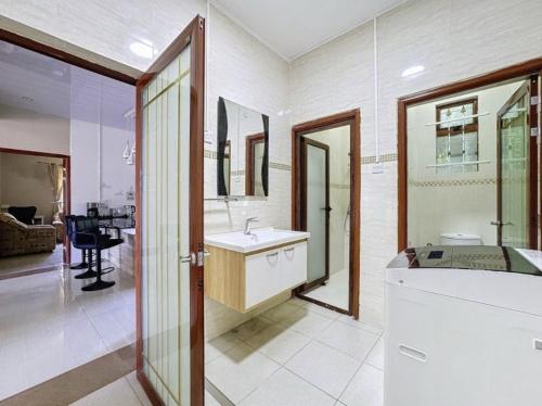 a bathroom with a sink and a large mirror at Residence Acacia in Port Louis