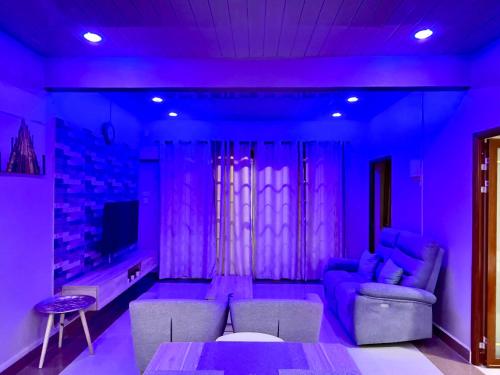 a purple room with a couch and a table at Residence Acacia in Port Louis