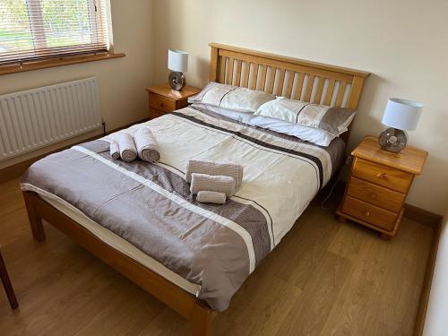 a bedroom with a large bed with two night stands at Home in Foxford, 8 Guests in Rinnananny