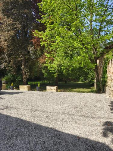 a gravel parking lot with trees in a park at La maison des Bretzels GÎTE jacuzzi et charme Alsacien in Pfaffenhoffen