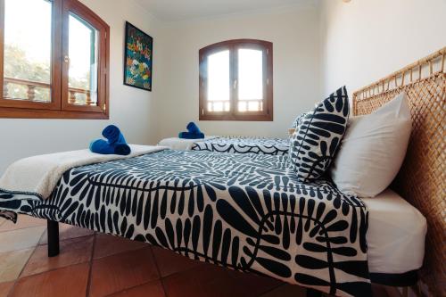 a bedroom with a bed with a zebra printed comforter at Traumhafte Finca auf Mallorca mit Pool 1A Lage direkt am Meer bei Es Trenc Bootstouren auf Anfrage möglich in Sa Ràpita