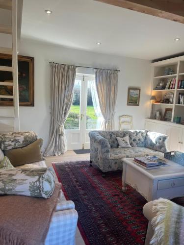 a living room with a couch and a table at Drummin Cottage in Tinahely