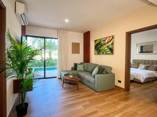 a living room with a couch and a bed at Oasis Retreat 2 Bedroom with Private Pool, Gated in Punta Cana