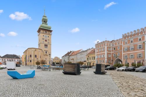a city square with a clock tower and buildings at sgrafit apartments - Self Check-In in Retz