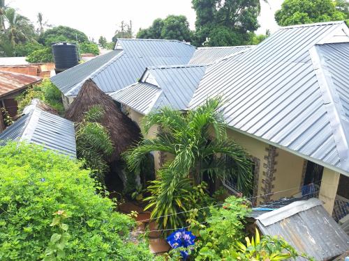 a roof of a house with palm trees and plants at Mount Zion Guest House, Mtwapa Mtomondoni in Mombasa