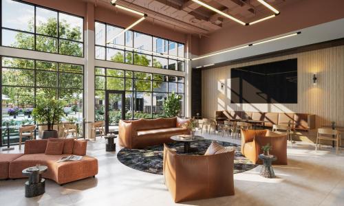 a lobby with leather furniture and a large wall of windows at Luxury Apartments by Hyatus at Boston Everett in Everett