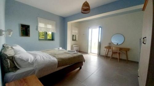 a bedroom with a bed and a table in it at Marmaras Mani Houses in Riglia