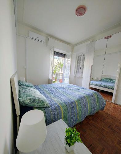 a bedroom with a bed and a white chair at Foce24 - City Garden - in Imperia