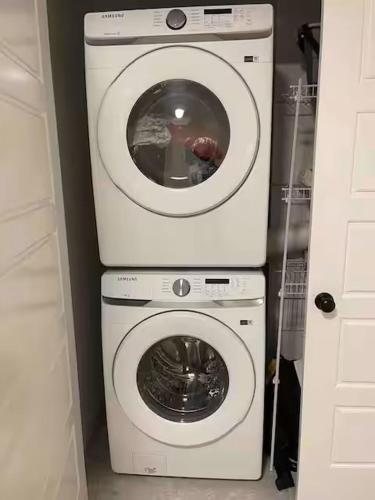 a washing machine and a dryer in a room at Bedroom in Upland B in Edmonton