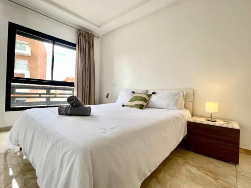 a bedroom with a large white bed and a window at luxury Aprt2 bedrooms Pool hivernage heart of city in Marrakech
