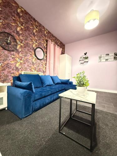 a living room with a blue couch and a table at The Lavender City Stay in Chesterton