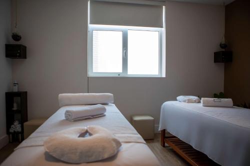 a bedroom with two beds with a donut on the bed at Casa Andina Premium San Isidro in Lima
