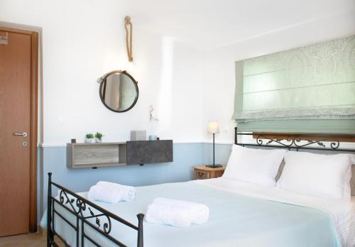 a bedroom with a bed with two towels on it at Oikia Kastri Sithon in Skála Nikíta