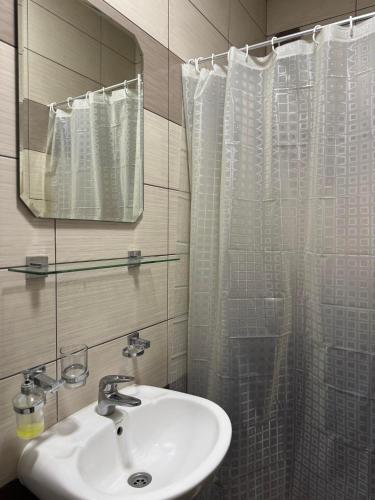a bathroom with a sink and a mirror at Apartmants S&H in Ulcinj