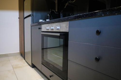 a kitchen with a stove and a counter top at Tritea Apartments in Golem