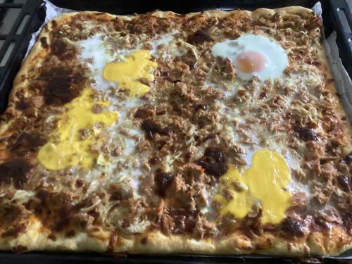 a pizza with an egg on top of it at B&B Villa Maurizio in Tskaltubo