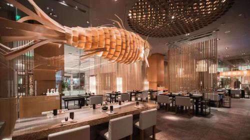 a restaurant with a large shell hanging from the ceiling at Pudong Shangri-La Shanghai - With a sweeping view of the Pearl Tower and the historic Bund skyline in Shanghai