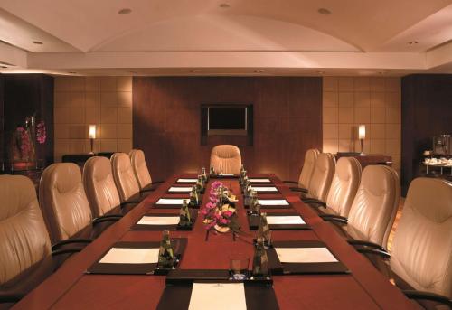 a conference room with a long table and white chairs at Pudong Shangri-La Shanghai - With a sweeping view of the Pearl Tower and the historic Bund skyline in Shanghai