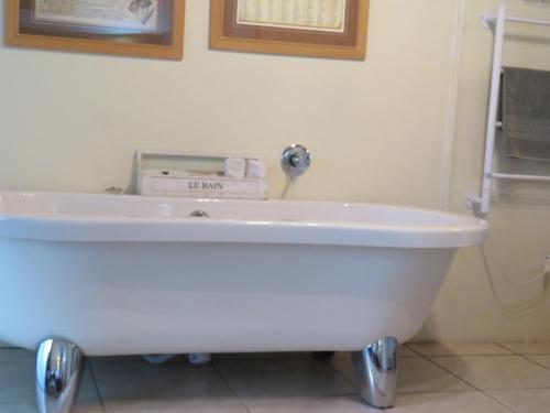 a white bath tub sitting in a bathroom at Tsitsikhaya Lodge in Stormsrivier