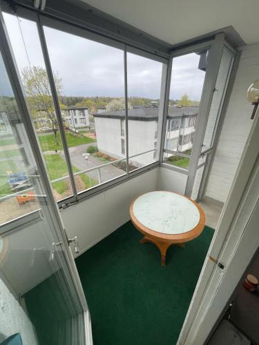 a room with a table in a room with windows at The castle & stay in Örebro