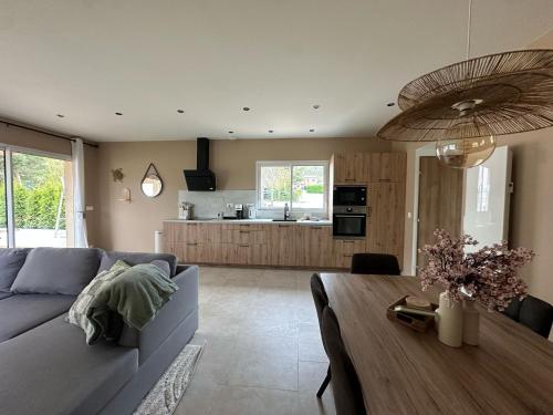 a living room with a couch and a table at La Maison Myrtille in Castellane