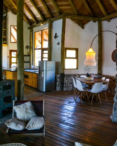 a kitchen and dining room with a table and a refrigerator at La Richard Refugio Boutique in Dique Nivelador