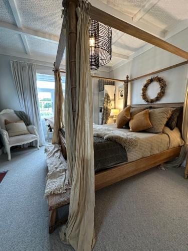 a bedroom with a canopy bed in a room at The Hidden Gem in Cambridge - One to Two Bedroom Suite in Cambridge