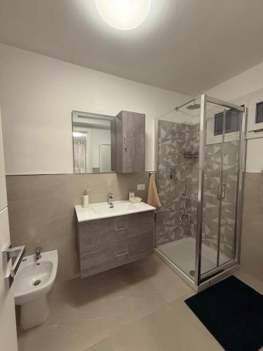 a bathroom with a sink and a shower and a toilet at Arsi House in Diano Castello