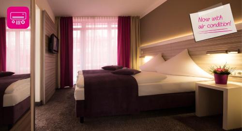 Hotel Mirabell by Maier Privathotelsにあるベッド