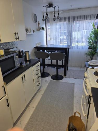 a kitchen with a table and a dining room at Lugn & Ro på Vändstigen in Nybro