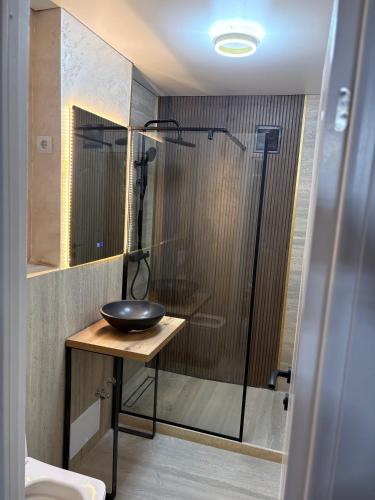 a bathroom with a sink and a glass shower at Sunset LOFT Mangalia in Mangalia