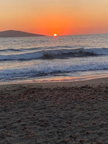 a sunset on the beach with the ocean at Studio Saroukos in Kalymnos