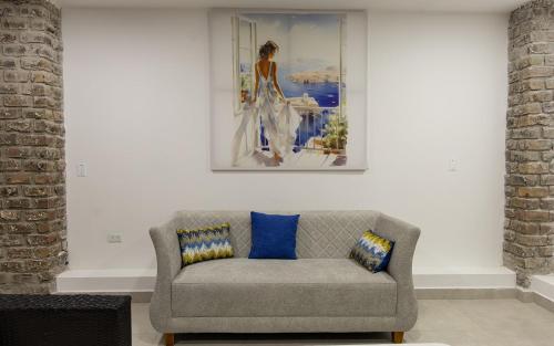 a couch in a living room with a painting on the wall at Residencia las bahias 175 in San Bartolo