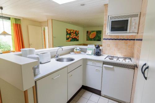 a kitchen with a sink and a counter top at Center Parcs Bispinger Lüneburger Heide in Bispingen