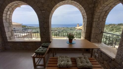 a room with a table and a view of the ocean at Marmaras Mani Houses in Riglia
