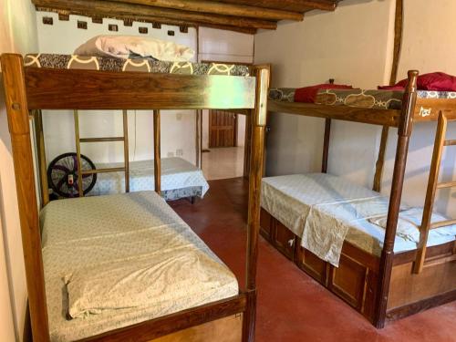 a group of bunk beds in a room at Popoyo Surf House Guasacate in La Albina