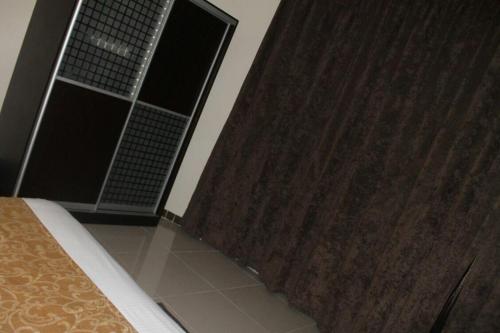 a bedroom with a bed and a wooden shower curtain at دولف للشقق المخدومة in Riyadh