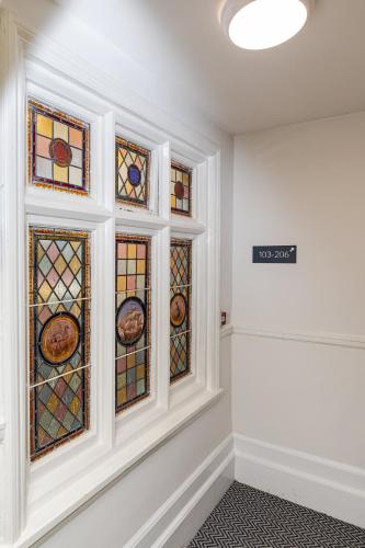 a room with stained glass windows on the wall at Woodford Hotel in London