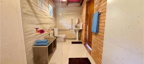 a small bathroom with a toilet and a sink at Chalé Ecológico na Natureza in Piedade