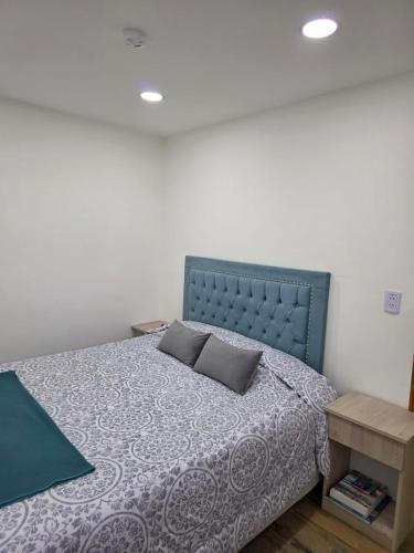 a bedroom with a bed with two pillows on it at Sur Bonito in Río Grande
