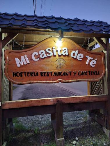 a wooden sign for a micta be tntaria restantancy center at Departamentos Mi Casita de Té in La Junta