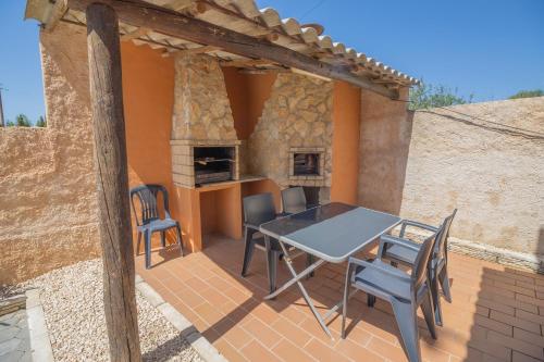 a patio with a table and chairs and a fireplace at Quinta Gomes in Lagos