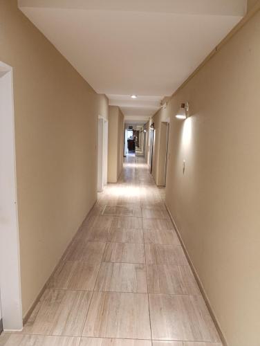 an empty hallway of an apartment with a tile floor at Hotel Menfis in San Francisco