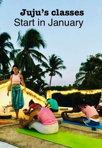 a group of people laying on mats on the beach at Villa Poesía in Puerto Escondido