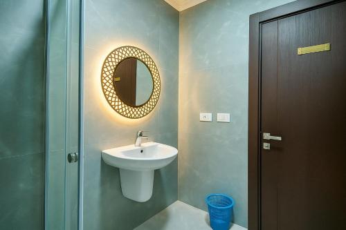 a bathroom with a sink and a mirror at Luxurious Chalet in Port Said Governorate with Breathtaking View in Port Said