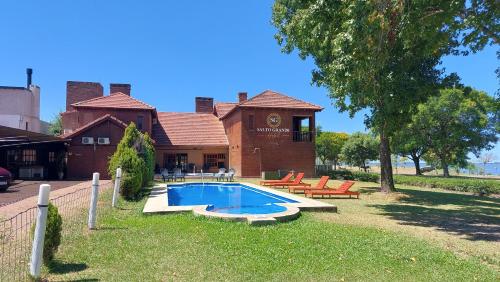 a house with a swimming pool in the yard at Hotel Salto Grande in Federación