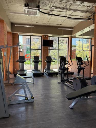 a gym with a lot of treadms and pilates equipment at Stylish New Loft in Financial Zone and Downtown in Guadalajara