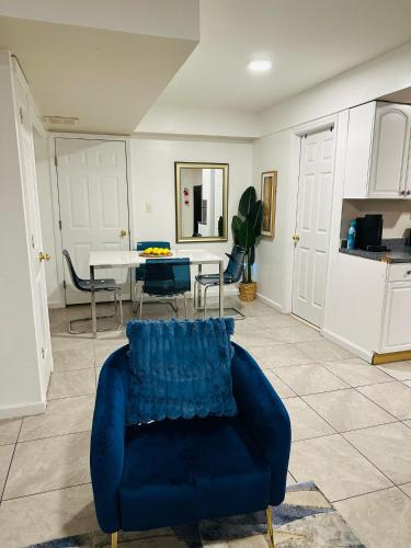 a living room with a blue couch and a table at Cosy Bedroom 6 minutes to EWR Prudential Hotels Pen station in Newark