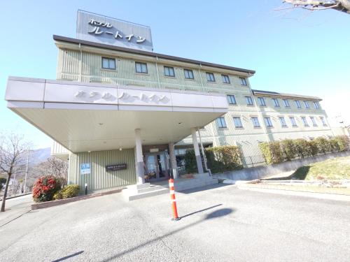 a building with a sign on the front of it at Hotel Route-Inn Court Minami Alps in Minami Alps