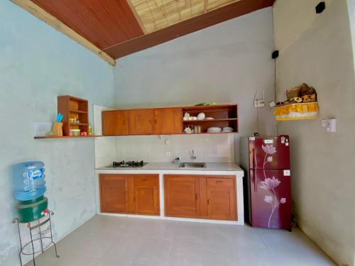 a kitchen with a sink and a refrigerator at Pranajaya loka villa in Tejakula